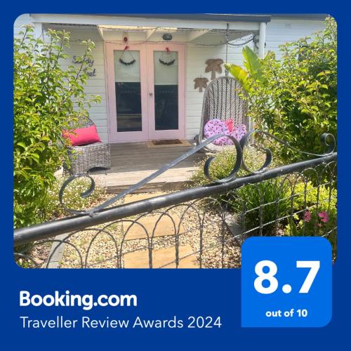 a front porch of a house with a pink door at Gorgeous Renovated Cottage in Heart of Victor in Victor Harbor