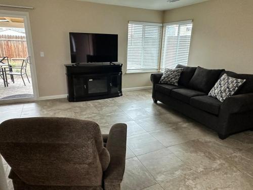 a living room with a couch and a television at Casa Cortez C in Visalia