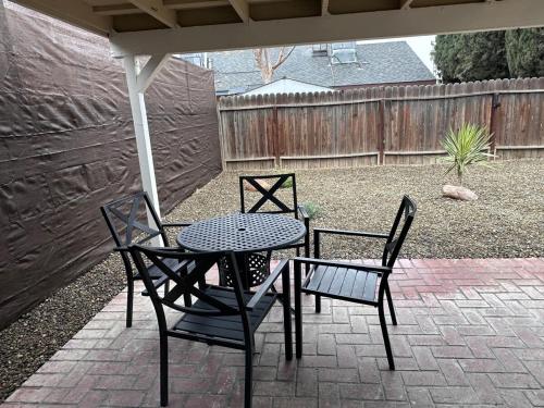 a patio with a table and two chairs and an umbrella at Casa Cortez C in Visalia
