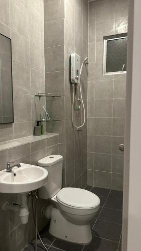 a bathroom with a toilet and a sink at 9 Beradik Homestay in Kajang