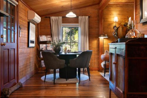 a dining room with a table and chairs and a window at All Views in Daylesford