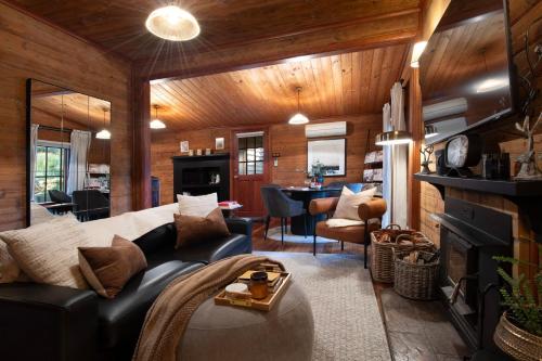 a living room with a couch and a fireplace at All Views in Daylesford