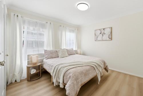 a white bedroom with a bed and a window at Bellbird Willow Hunter Escape by Nature & Winery in Bellbird