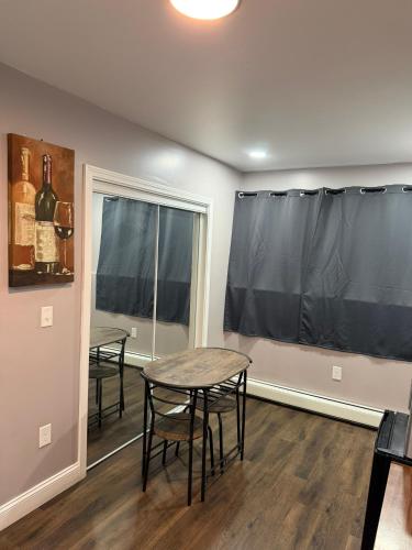 a dining room with a table and chairs and a window at Basement room with its own private bathroom in Providence