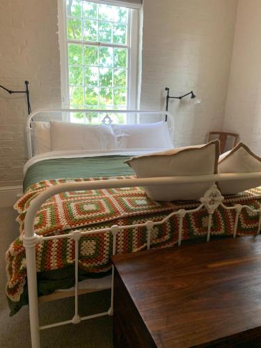 a bedroom with a white bed with a window at The Ol' Sunday School in Ross