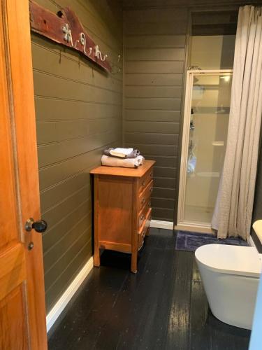 a bathroom with a sink and a toilet and a tub at The Ol' Sunday School in Ross