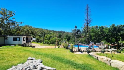 a large yard with a house and a pool at The Hidden Gem of Landsborough in Landsborough