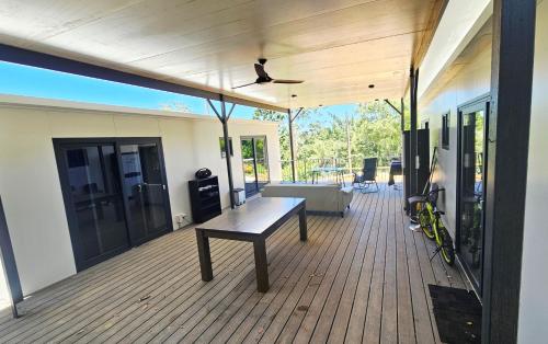 a porch with a bench on a wooden deck at The Hidden Gem of Landsborough in Landsborough