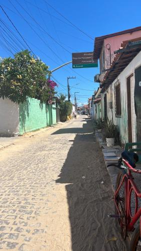 a bike parked on the side of a street at Pé na festa in Aracati