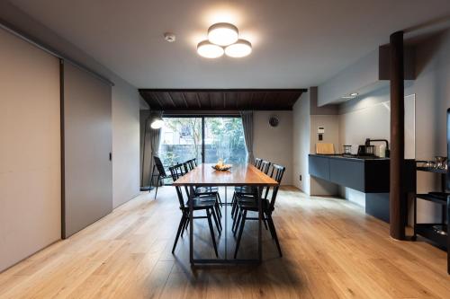 a dining room and kitchen with a table and chairs at SAKON UKON in Kanazawa