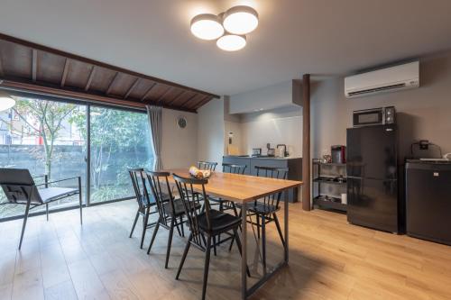 a kitchen and dining room with a table and chairs at SAKON UKON in Kanazawa
