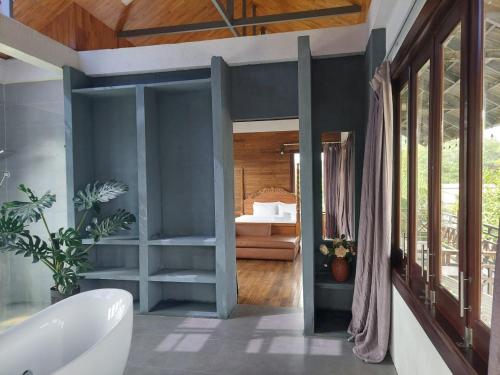 a bathroom with a white tub and a bedroom at Thao’s Villa in Ho Chi Minh City