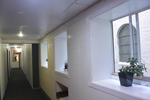 a hallway in a building with a window at Elizabeth Hostel in Melbourne