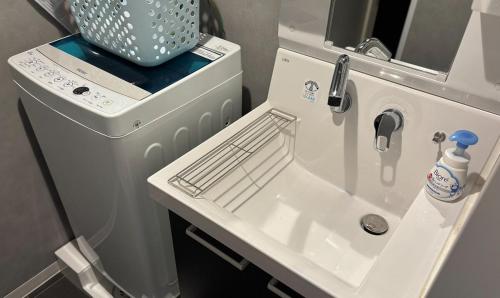 a bathroom with a sink and a washing machine at SALE Flawed Property with a loud music from neighbor but stay cheap in nice area in Tokyo