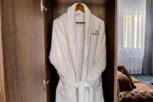 a robe hanging on a door in a hotel room at INFINITY PLAZA BLOCK 1 in Atyraū
