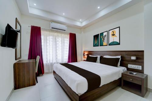 En eller flere senge i et værelse på Collection O RTO Office Uzhavoor Formerly Hotel Zodiac