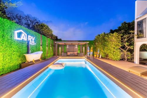 a swimming pool in the backyard of a house at Bangkok Cozy Garden Pool Villa Sukhumvit in Amphoe Phra Khanong