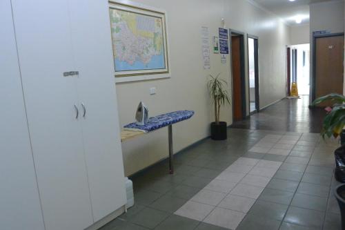 a hallway with a blue bench in a building at Elizabeth Hostel in Melbourne