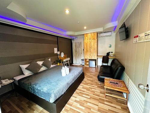 a bedroom with a large bed and a couch at Viphuanan Resort in Nong Prue