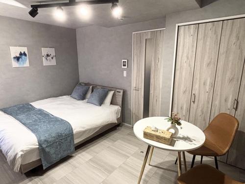 a small bedroom with a bed and a table at SALE Flawed Property with a loud music from neighbor but stay cheap in nice area in Tokyo