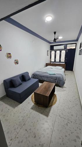 a bedroom with a bed and a couch at The Nook in Pondicherry