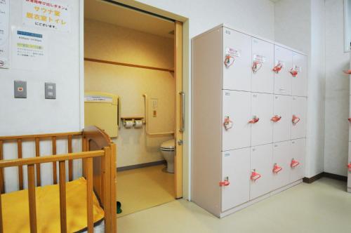 a hospital room with a toilet and a locker at Highland Furano in Furano