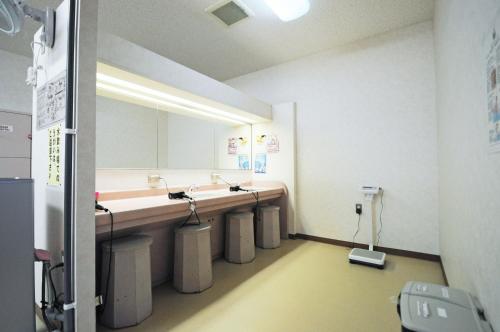 a bathroom with two sinks and a large mirror at Highland Furano in Furano