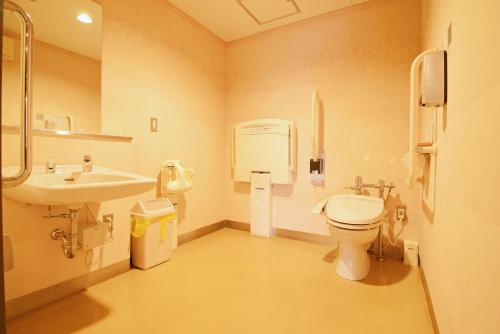 a bathroom with a toilet and a sink at Highland Furano in Furano