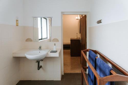 a bathroom with a sink and a mirror at The 6th Milepost Tea Bungalow Bandarawela in Bandarawela