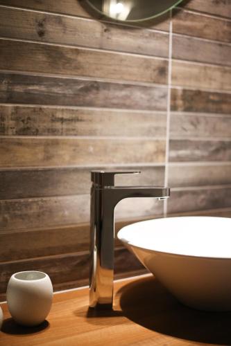 a bathroom with a sink and a mirror at Penzion Recall in Troskovice
