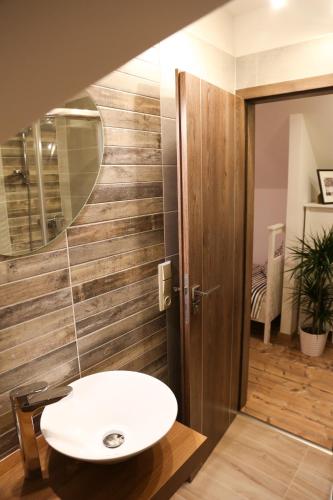 a bathroom with a sink and a mirror at Penzion Recall in Troskovice