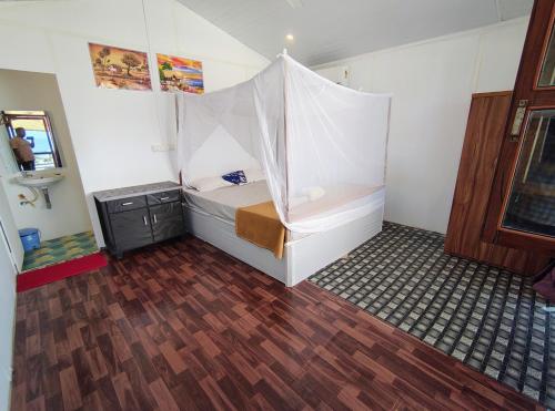 a room with a bed with a tent in it at Mountain Palm patnem beach in Patnem