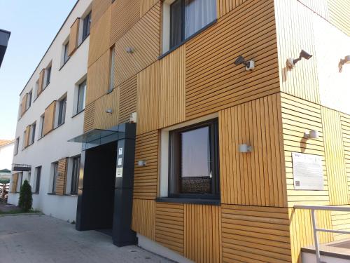 a building with wooden panels on the side of it at Panorama Business Inn in Cluj-Napoca