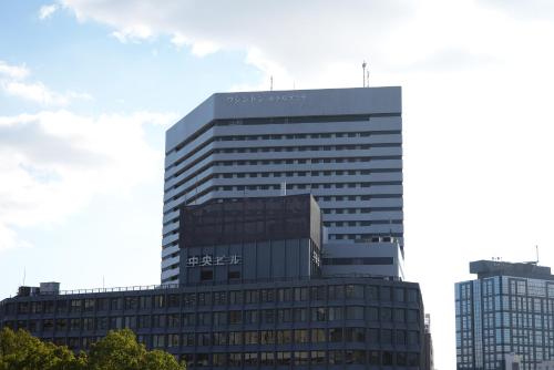 a tall building with a sign on the side of it at Shin Osaka Washington Hotel Plaza in Osaka