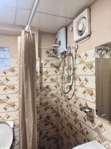 a bathroom with a shower curtain and a sink at SEBASTIAN TRANSIT KATUNAYAKE in Katunayaka