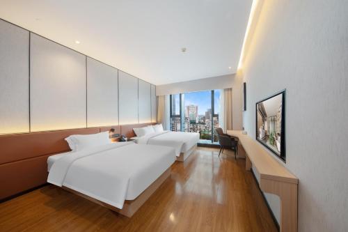 Postel nebo postele na pokoji v ubytování Elong Ruige, Dafosi Branch, Beijing Road Pedestrian Street, Guangzhou