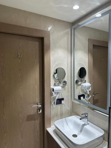 a bathroom with a sink and a mirror at Arth Boutique Hotel in Kota