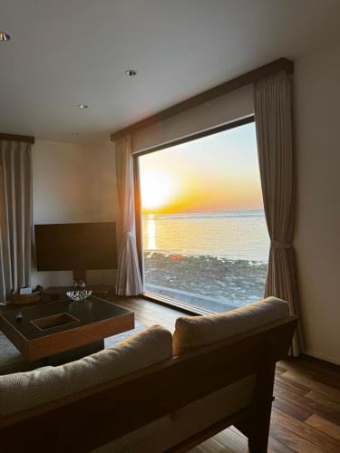 a living room with a large window with a view of the ocean at HERO VILLA ocean suite in Ishigaki Island