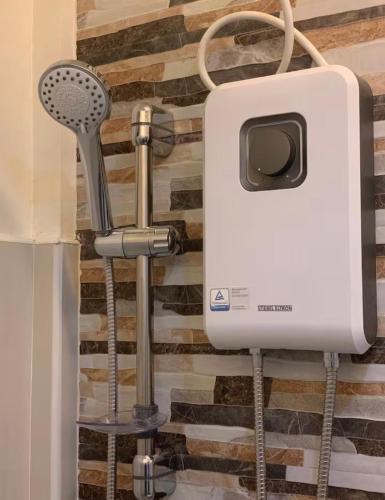 a soap dispenser on the wall of a bathroom at Piccadilly Green Villas Apartment in Dauis