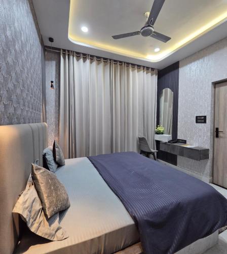 a bedroom with a bed and a ceiling fan at Hotel Ram Ghar - Near Mathura Junction Railway Station in Mathura