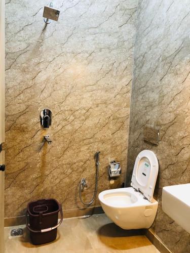 a bathroom with a toilet and a shower at Hotel Ram Ghar - Near Mathura Junction Railway Station in Mathura