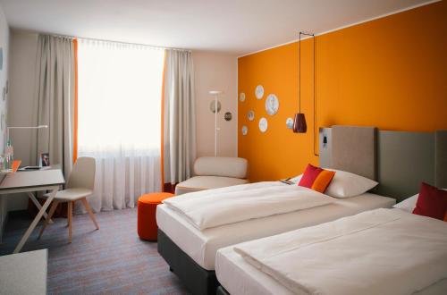 Postel nebo postele na pokoji v ubytování Vienna House Easy by Wyndham Wuppertal