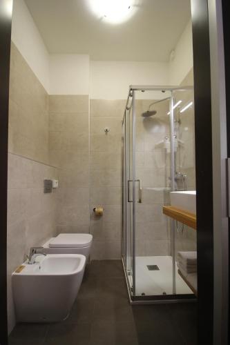 a bathroom with a shower and a toilet and a sink at Hotel Salieri in Legnago