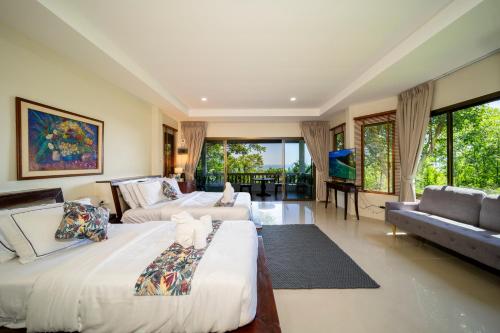 a large room with two beds and a couch at Chaweng Bay View Resort by Smith & Appy in Ko Samui
