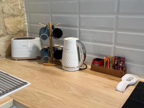 a counter top with a toaster and a coffee maker at 'I Elea' Village House with Courtyard in Letimbou