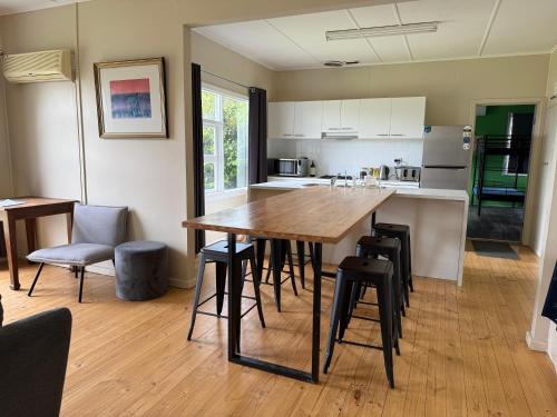 a kitchen with a wooden table and some chairs at Cooinda Retreats - The Residence in Victor Harbor