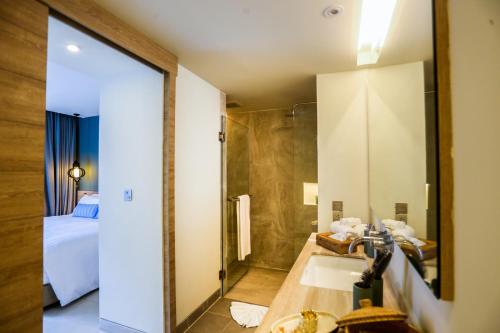 a bathroom with a sink and a large mirror at Fusion Suites Phuket Patong in Patong Beach