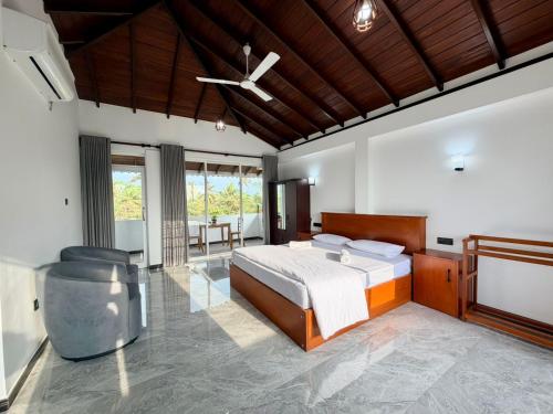 a bedroom with a bed and a ceiling fan at Turtle Bay Resort Hikkaduwa in Hikkaduwa