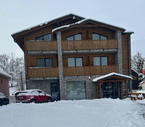 a house with a car parked in front of it at Berg Liptov in Liptovský Mikuláš