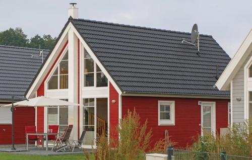a red house with a black roof at Haus Hafenidyll in Wandlitz